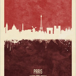 May include: A watercolor-style illustration of the Paris skyline, featuring the Eiffel Tower, the Arc de Triomphe, and other iconic landmarks. The skyline is set against a red background with a brown watercolor wash at the bottom. The text "PARIS - FRANCE" is printed below the skyline.