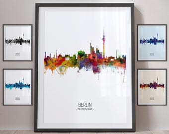 May include: A watercolor painting of the Berlin skyline with the text "BERLIN - DEUTSCHLAND -" at the bottom. The skyline is in shades of blue, green, red, orange, and yellow.