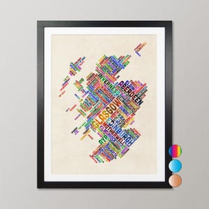 The image is a framed collage of various words and phrases, likely representing different cities or locations, arranged in a visually striking and colorful manner.