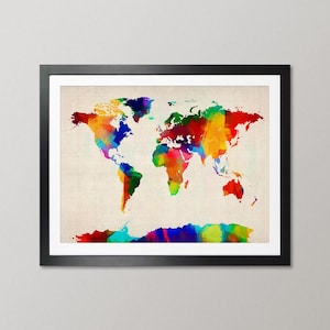 May include: A framed wall art print featuring a world map rendered in vibrant, multi-colored watercolor splashes. The continents are depicted in shades of red, blue, green, yellow, and purple against a textured, light beige background.
