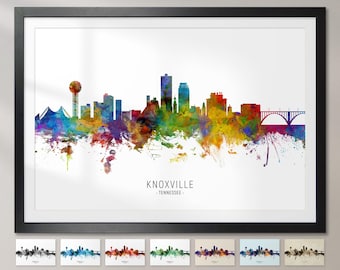 May include: A colorful watercolor cityscape of Knoxville, Tennessee. The skyline features a variety of buildings, including a tall tower, a bridge, and a few skyscrapers. The city is depicted in a vibrant palette of blues, greens, yellows, and oranges.