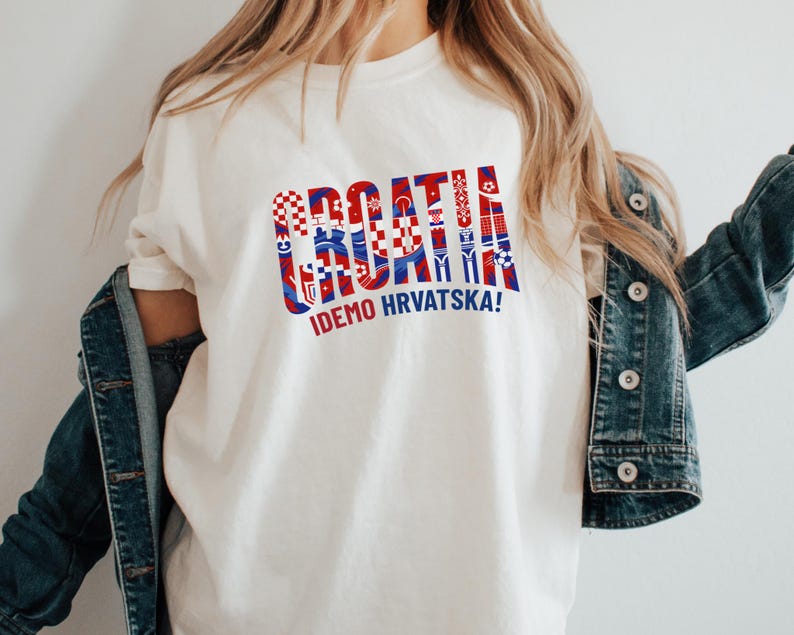 A person wearing a white t-shirt with the text "Croatia" and "IDEMO HRVATSKA!" printed on it, along with a denim jacket.