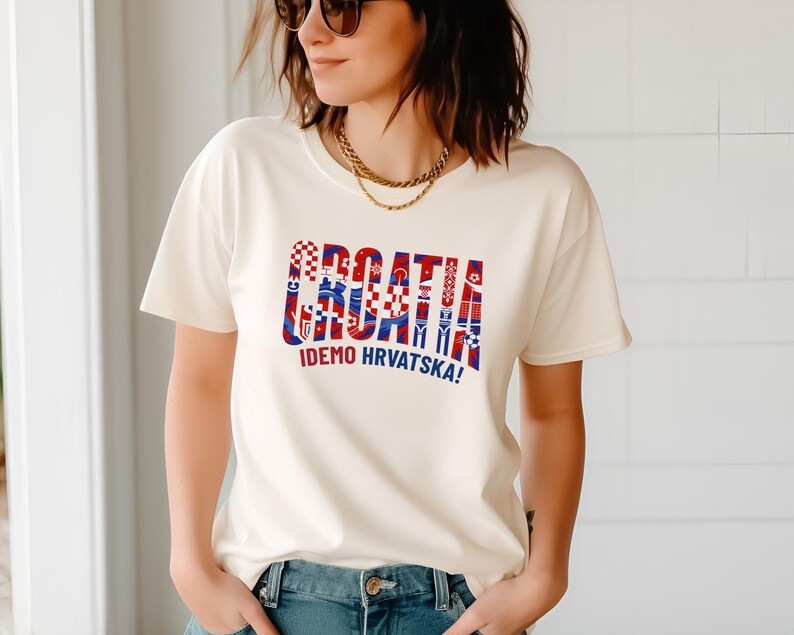 A woman wearing a white t-shirt with a graphic design and text printed on it.