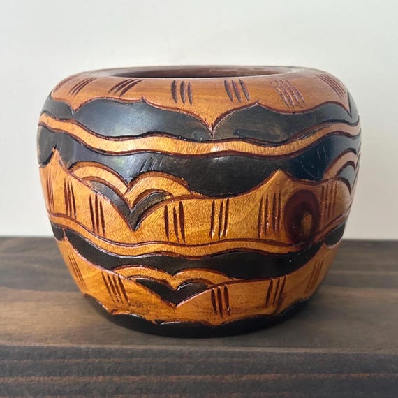 A genuinely vintage Haitian mahogany bowl with hand-etched tribal geometry in two-tone relief — real folk art with provenance, not a reproduction.