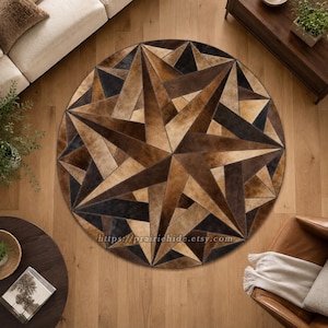 May include: A circular rug featuring a geometric star pattern composed of stitched hide panels in various shades of brown, tan, and dark charcoal. The surface displays a complex arrangement of triangular shapes and the text https://prairiehide.etsy.com.