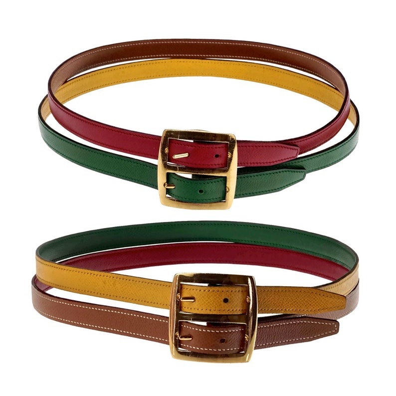 Pode incluir: Um cinto de couro multicolorido com uma fivela dourada. O cinto &eacute; feito de quatro cores diferentes de couro: marrom, amarelo, vermelho e verde. A fivela &eacute; uma fivela de dupla ponta.