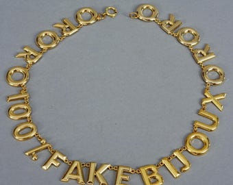 Collana vintage con lettere MOSCHINO "ORO 100% FAKE"