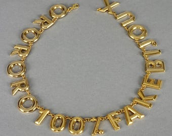 Collana vintage Moschino con la scritta "ORO 100% FAKE BIJOUX"