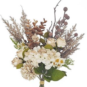 May include: A floral arrangement featuring cream-colored roses, white hydrangea blossoms, and small daisies with yellow centers. The bouquet includes brown eucalyptus leaves, dried grasses, thin bare twigs with round berries, and green foliage.