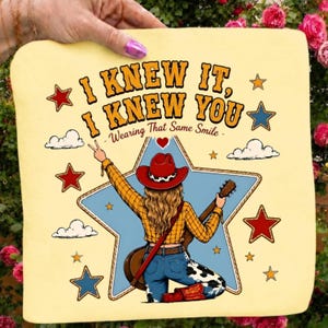 May include: A light yellow fabric square featuring a graphic of a person in a red cowboy hat, yellow plaid shirt, and cow-print jeans holding a guitar. The text reads I KNEW IT, I KNEW YOU, Wearing That Same Smile, surrounded by stars and clouds.