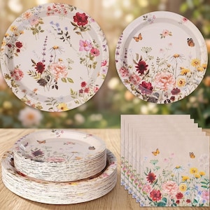 May include: A set of disposable paper plates and napkins featuring a botanical print with various colorful flowers, including red, pink, and yellow blossoms, along with small butterflies on a light cream background, arranged in stacks.