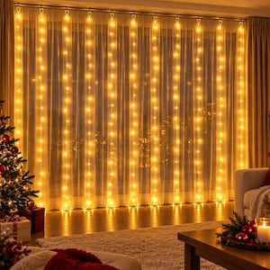 May include: A curtain of warm white LED string lights hanging vertically in front of a sheer window drape. The lights are arranged in multiple parallel strands, creating a glowing grid effect that illuminates the room with a soft golden light.