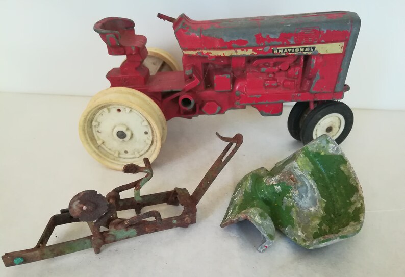 Twenty Pieces Toy John Deere International Hubley Farm Tractor Parts