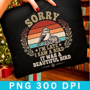 May include: Black pillow with a retro design featuring a bird and a mouse, set against a sunset-colored background. The text reads "SORRY" and "I'M LATE I SAW A BIRD IT WAS A BEAUTIFUL BIRD".