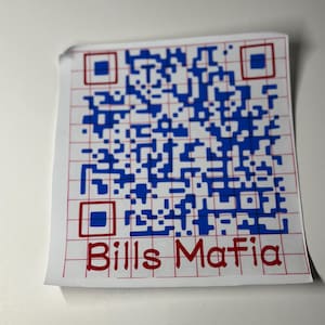 May include: A white sticker with a blue and white QR code and red grid lines. The words "Bills Mafia" are printed in red at the bottom of the sticker.