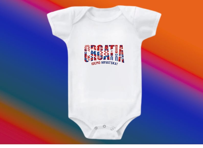 May include: White baby bodysuit with the word "CROATIA" in red, white, and blue, with the text "IDEMO HRVATSKA!" below. The bodysuit has short sleeves and a snap closure. The background is a gradient of blue, red, and orange.