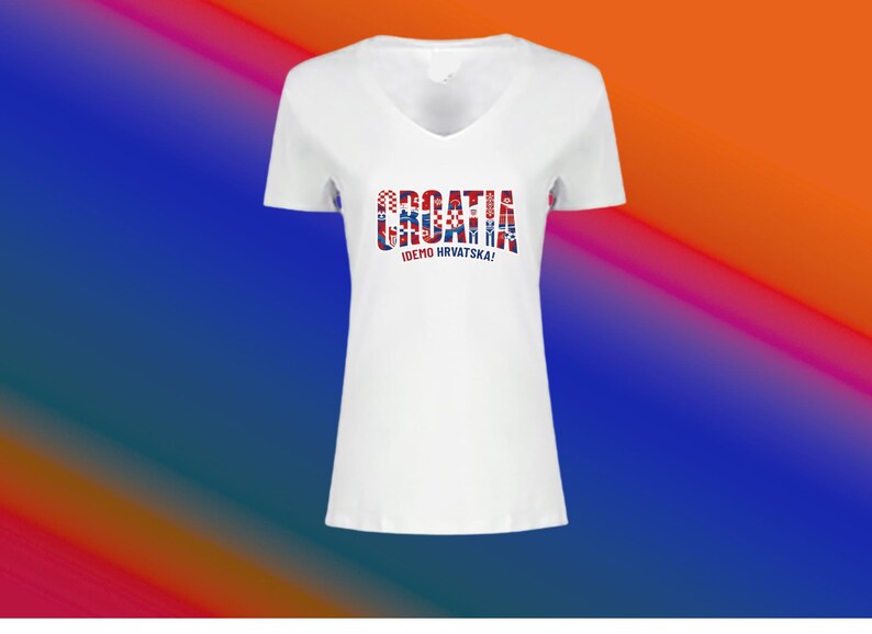 May include: White V-neck t-shirt with the word "CROATIA" in red, white, and blue, and the text "IDEMO HRVATSKA!" below. The shirt has short sleeves and a simple design.