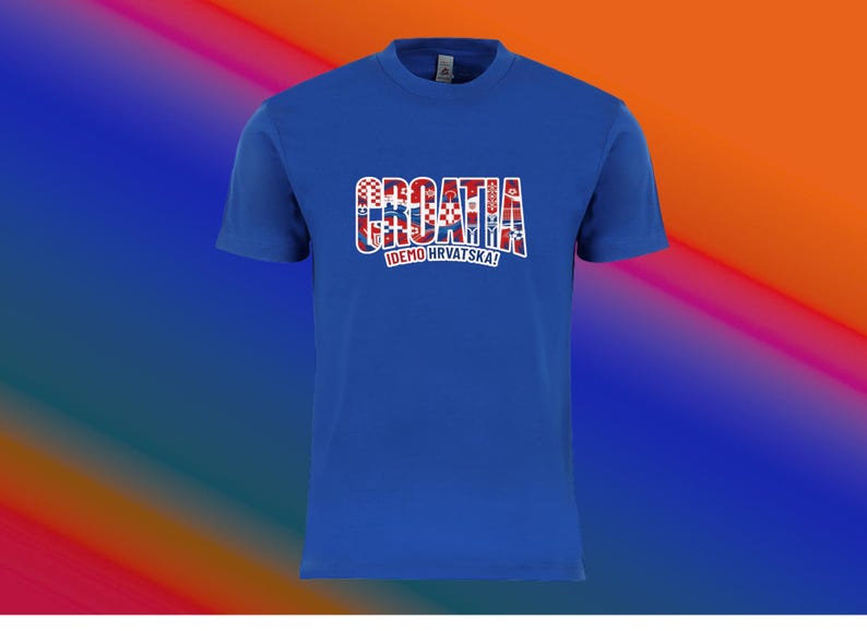 May include: A royal blue t-shirt with the word "CROATIA" in a red, white, and blue design across the chest. Below the word "CROATIA" is the text "IDEMO HRVATSKA!" in white. The shirt has short sleeves and a crew neck.