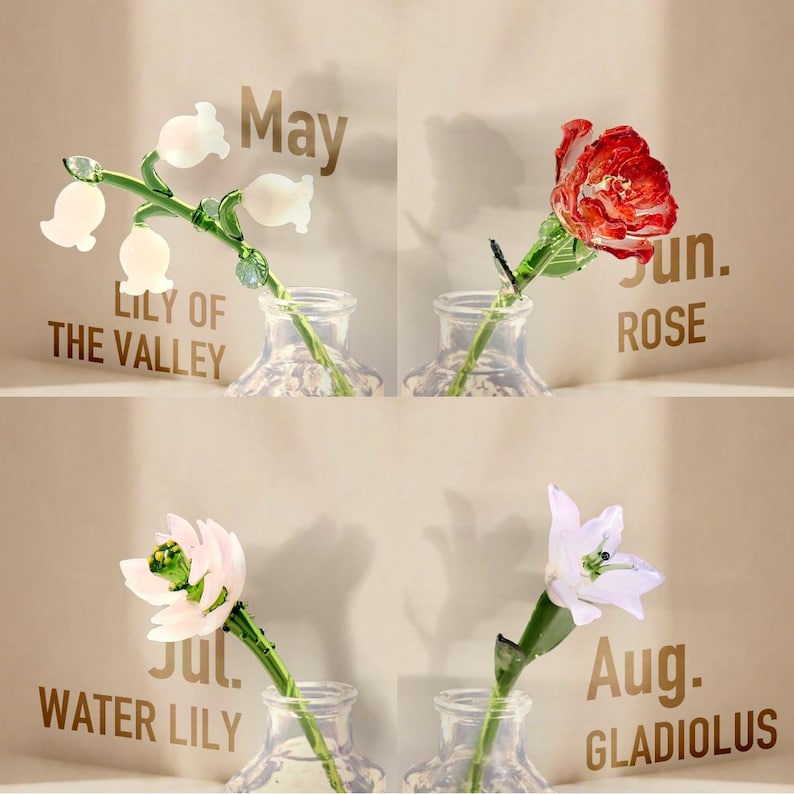 May include: Four glass flowers in clear glass vases, each labeled with a month and name: May Lily of the Valley with white bell-shaped blooms, Jun. Rose with red petals, Jul. Water Lily with pale pink petals, and Aug. Gladiolus with white petals.