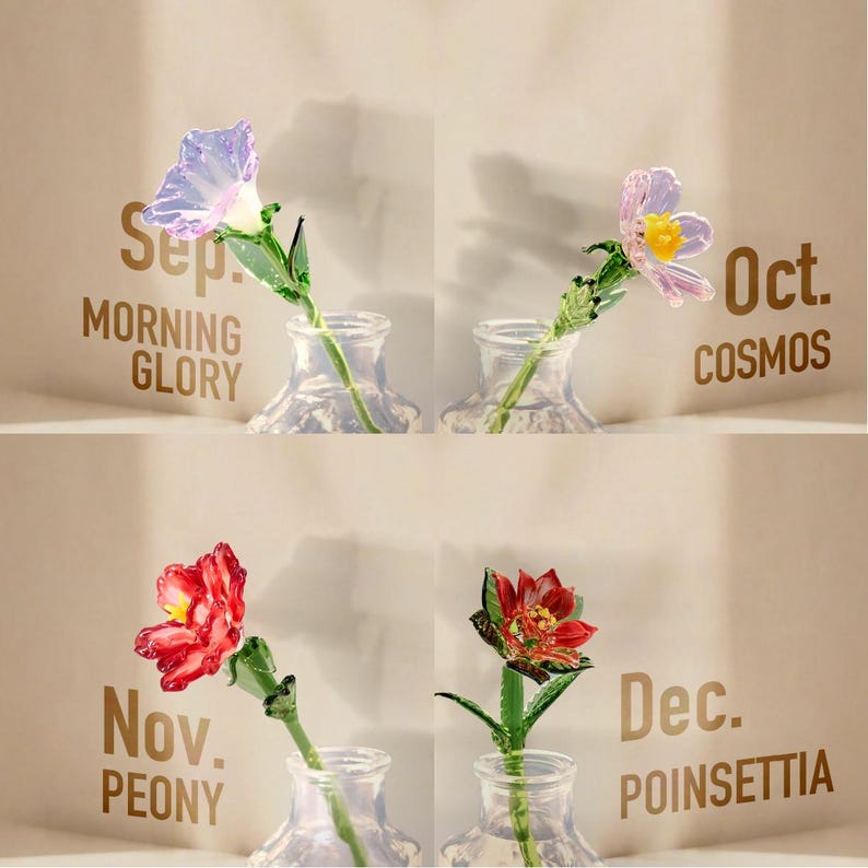 May include: Four glass flowers in clear glass vases, each labeled with a month and flower name: Sep. Morning Glory, Oct. Cosmos, Nov. Peony, and Dec. Poinsettia. The flowers feature translucent petals in purple, pink, red, and green glass stems.