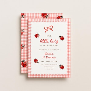 May include: A rectangular birthday invitation card featuring a red and white gingham pattern border with watercolour ladybird illustrations. The centre white panel has a scalloped edge, a red bow icon, and text reading: Our little lady is turning one! Anna's 1st Birthday.