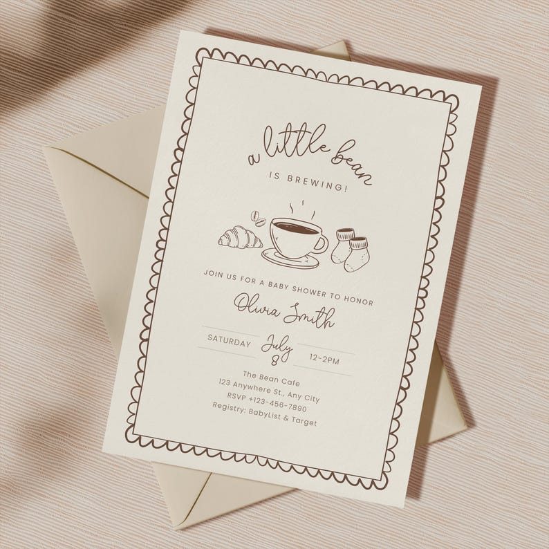 May include: A baby shower invitation with a scalloped border and the words "a little bean is brewing!" in a script font. The invitation includes illustrations of a coffee cup, croissant, and baby socks. The invitation is on a cream-colored background.