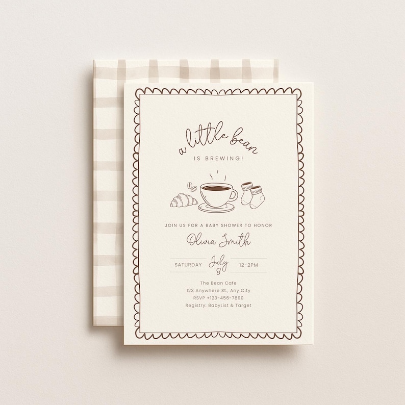 May include: Cream-colored baby shower invitation with a scalloped border and a beige plaid envelope. The invitation features the text "a little bean is brewing!" and includes illustrations of a croissant, coffee cup, and baby socks.