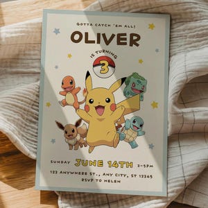 May include: A light blue invitation card with the text "GOTTA CATCH 'EM ALL! OLIVER IS TURNING 3". The card features cartoon illustrations of Pikachu, Charmander, Bulbasaur, Squirtle, and Eevee. The date and time are also included.