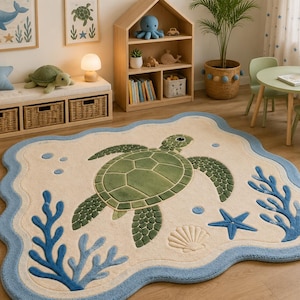 May include: A cream-coloured area rug with a scalloped blue border featuring a large green sea turtle in the centre, surrounded by blue coral, a blue starfish, a beige seashell, and small blue bubbles, all rendered in a soft, textured pile.