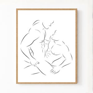 May include: A framed wall art print featuring a black line drawing on a white background. The illustration depicts two figures in an intimate embrace, focusing on the outlines of their muscular torsos, chests, and arms in a continuous line style.