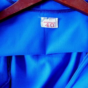 May include: A bright blue hooded shirt with a white tag that says "MARCADOR" and "40" in red.