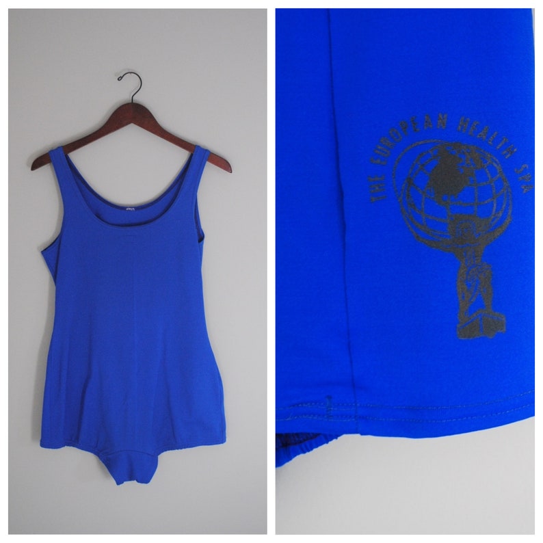 May include: A royal blue one-piece swimsuit with a black logo on the front that says "The European Health Spa".