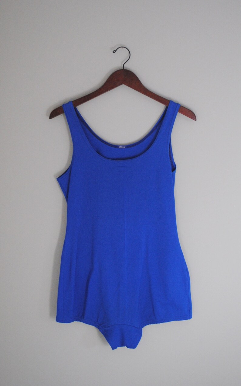 May include: A royal blue sleeveless swimsuit with a scoop neck.