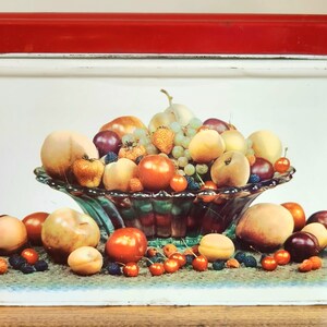 May include: White metal bread box with a red lid. The front of the box features a colorful illustration of a bowl overflowing with fruit, including peaches, apples, grapes, and plums.