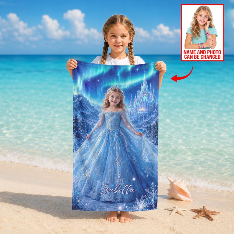 Op de afbeelding: Een gepersonaliseerde strandlaken met een jong meisje in een blauwe jurk, een kasteel en een noorderlicht achtergrond. De handdoek heeft de naam "Isabella" erop gedrukt. Een kleine foto met de tekst "NAME AND PHOTO CAN BE CHANGED" staat rechtsboven.