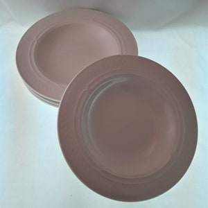 May include: Three white ceramic soup bowls with a raised rim and a decorative pattern around the edge.