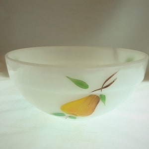 May include: White ceramic mixing bowl with a hand-painted design of a yellow pear with brown stem and green leaves.