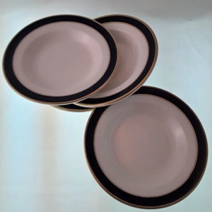May include: Three white ceramic bowls with a gold rim and a dark blue band around the edge.