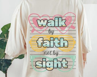 May include: Cream-coloured t-shirt featuring the phrase "walk by faith not by sight". The design incorporates the text within three pairs of glasses in pink, yellow, and teal. The shirt has a relaxed, oversized fit.