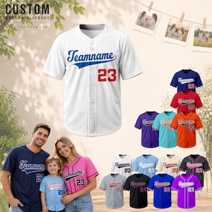 May include: A white short-sleeved baseball jersey with a button-down front, featuring the blue text Teamname and the red number 23 on the chest. The design includes a V-neck collar and a clean, athletic cut suitable for custom team apparel.