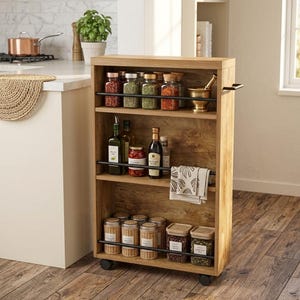May include: A tall, narrow, light brown wood kitchen storage cart with three shelves, each featuring a thin black metal safety rail. The cart is on wheels and contains various glass spice jars, bottles, a mortar and pestle, and a folded cloth.