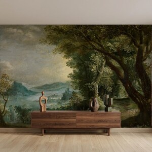 May include: A rectangular wooden sideboard with a smooth finish sits against a wall featuring a large-scale landscape mural. The mural depicts a dark, moody forest with dense green trees, distant mountains, and a castle under a cloudy sky.