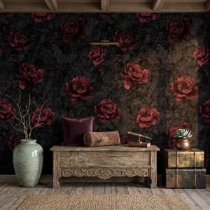 May include: A room with a dark floral wallpaper featuring large red roses. A distressed wooden bench holds a purple pillow, a decorative bolster, and a small telescope. A large green vase with branches and two antique trunks complete the scene.
