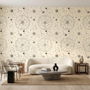 May include: Wallpaper featuring a repeating pattern of black celestial charts, zodiac wheels, and star constellations on a cream background. The design includes detailed circular astrological diagrams, various starburst shapes, and small planetary spheres.