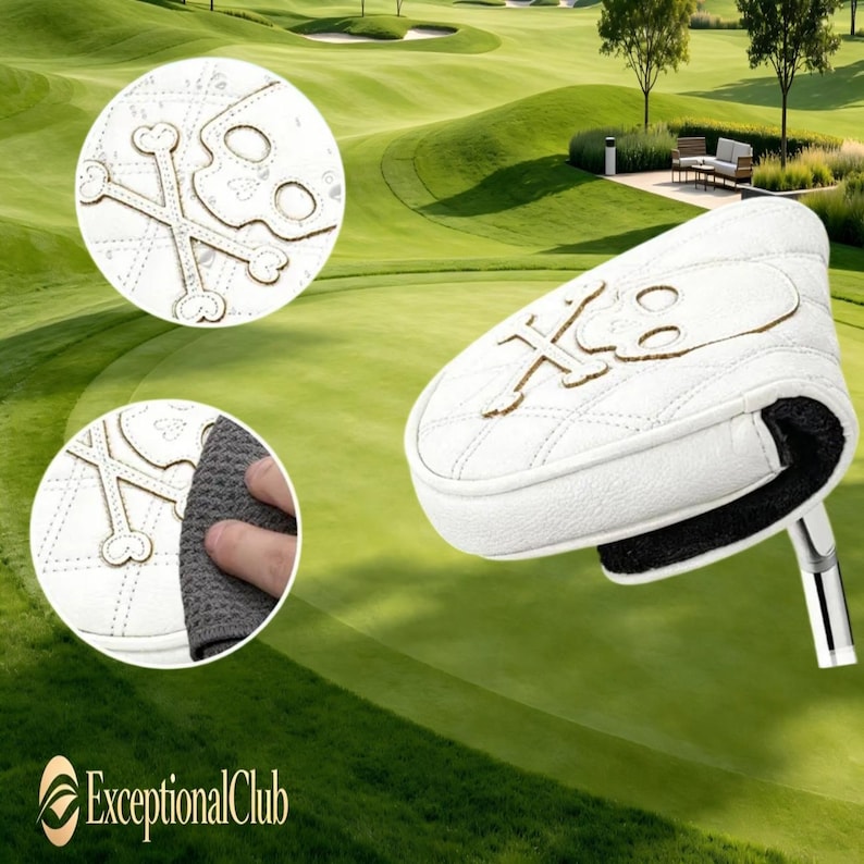 May include: A white golf putter headcover featuring a quilted diamond pattern and an embroidered skull and crossbones design. The cover has a textured white exterior with a black interior lining and a metallic silver shaft attachment point.