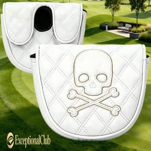 May include: A white mallet putter headcover featuring a quilted diamond pattern and an embroidered skull and crossbones design. The cover has a rounded shape with a black interior lining and a secure closure mechanism for golf equipment protection.