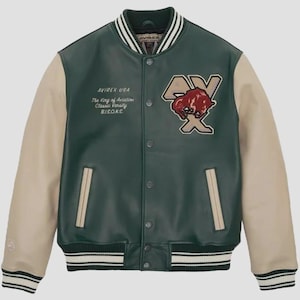 May include: Green and tan varsity jacket with the text "AVIREX USA The King of Aviation Classic Varsity Bisons." The jacket has a patch with a bison graphic and the letters "AX". The jacket has a striped collar, cuffs, and hem.