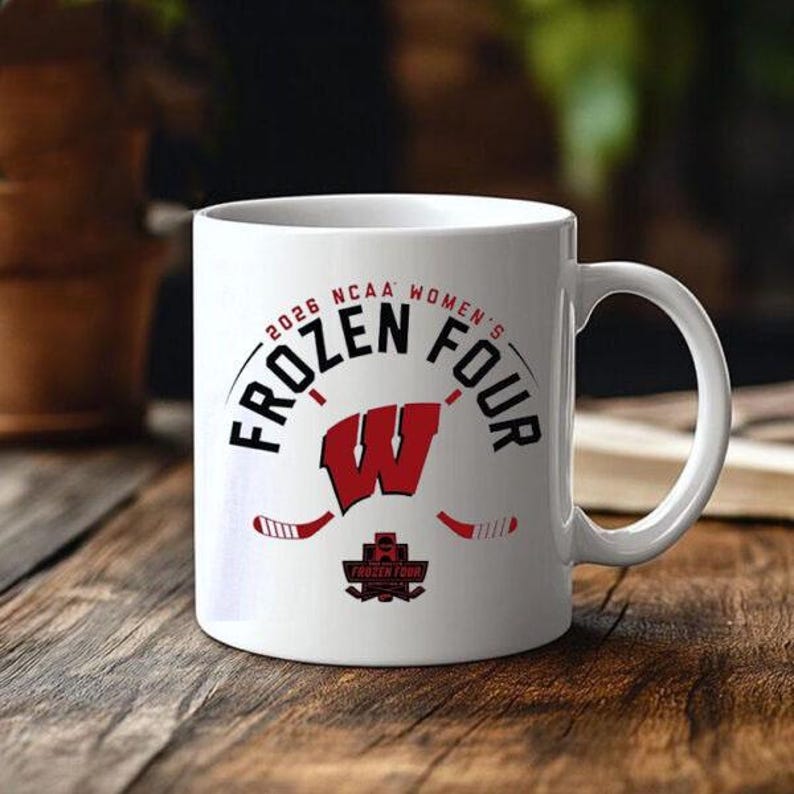 May include: White ceramic mug featuring the text "2026 NCAA Women's Frozen Four" in black and red. The mug includes a red "W" logo and hockey sticks. The bottom of the mug has the "Frozen Four" logo.