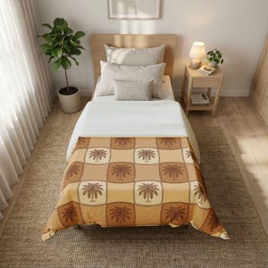 May include: A bed with a light wood headboard and a patterned blanket. The blanket features a repeating palm tree design in shades of brown and tan. The bed is made with white sheets and several pillows.