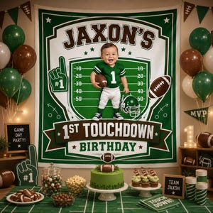 May include: A green and brown football-themed birthday backdrop featuring the text JAXON'S 1ST TOUCHDOWN BIRTHDAY, a child in a football uniform, balloons, a green cake, football-shaped treats, and signs reading GAME DAY PARTY and TEAM JAXON.